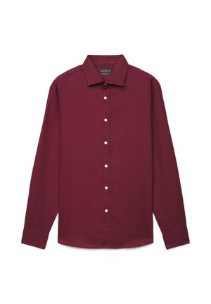 Chemise bordeaux à manches longues, boutonnée avec col et boutons blancs, présentée à plat sur un fond blanc.