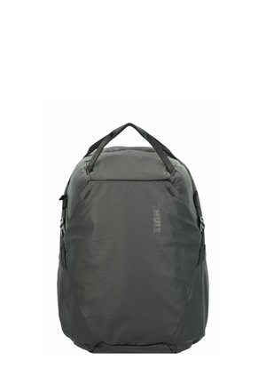 Gray backpack made of textured nylon, featuring padded straps, top handle, and side pockets. Minimalist design with a subtle logo.