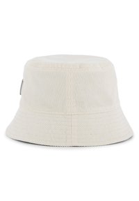 Chapeau seau en velours côtelé crème, avec un dessus plat, un large bord et un accent logo sur le côté. Design texturé à côtes sur toute la surface.