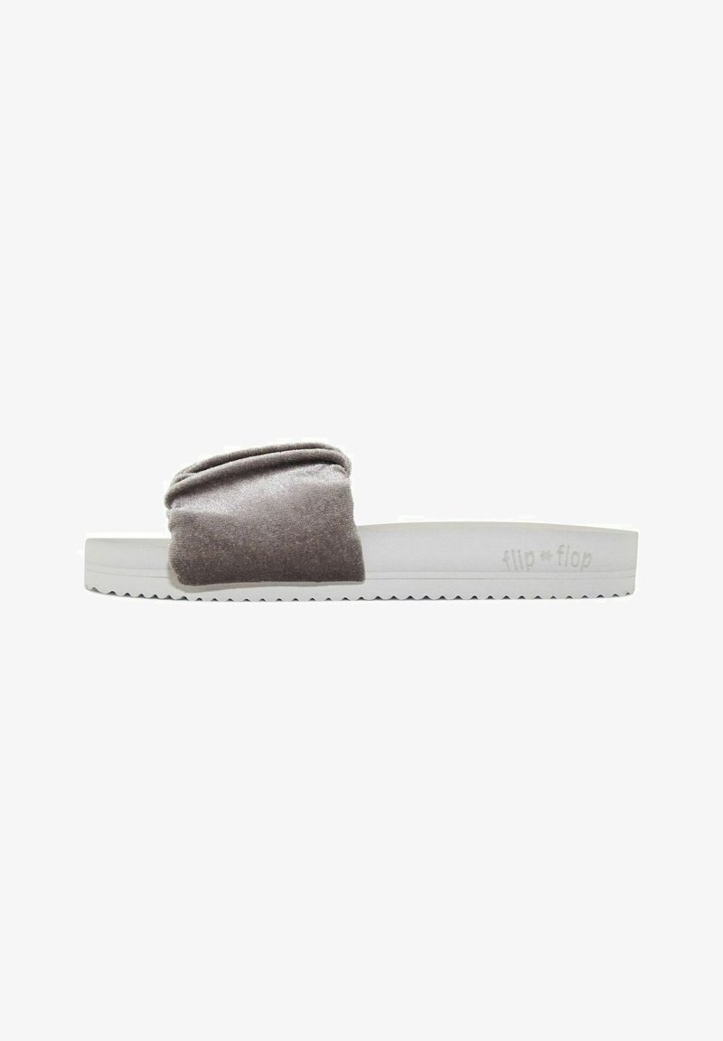 Gray fabric slide sandal with a ribbed texture on the strap, white rubber sole, and textured bottom for grip. Branding on the side.