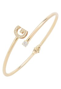 Gold bangle bracelet featuring a "G" logo encrusted with clear crystals and a single round gemstone, with a smooth, oval shape and secure clasp.