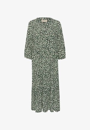Groene bloemenjurk met driekwart mouwen, een ronde halslijn en een uitlopende onderkant. Heeft een madeliefjespatroon op zachte, lichte stof.