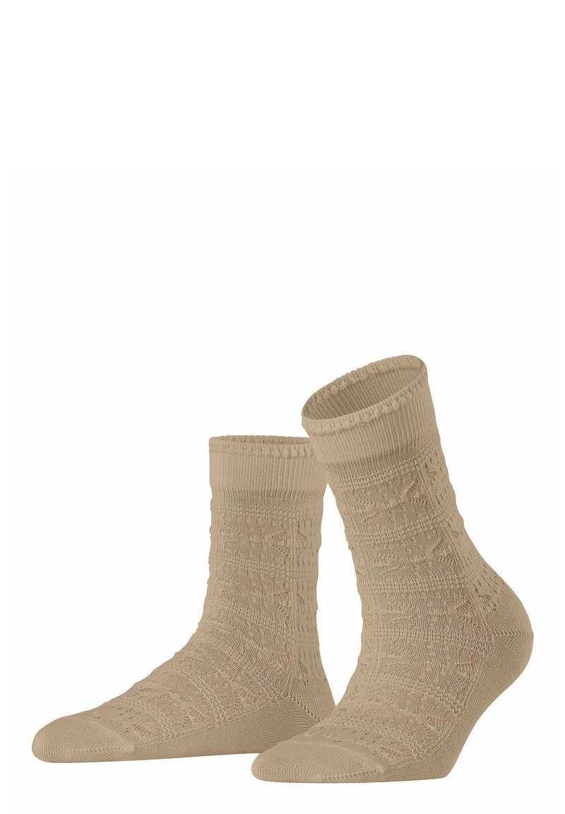 Beige gemusterte Socken mit einem strukturierten Design, ausgestattet mit einem gerippten Bündchen und einer verstärkten Zehenpartie. Hergestellt aus einem weichen, dehnbaren Material.