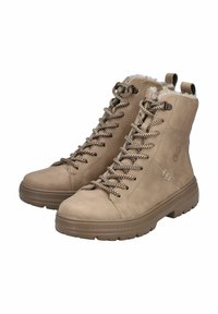 Bottines à lacets marron clair en suédine, dotées d'une doublure en fausse fourrure, de semelles en caoutchouc et de lacets à motifs.