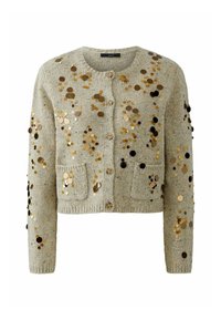 Lichtgrijze cropped cardigan met gouden en zwarte sequins, gestructureerde stof, ronde halslijn en twee voorkwasten. Sluiting met vier knopen.