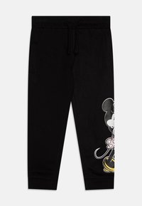 Pantalones deportivos negros de algodón, con cintura elástica, cordón y un gráfico colorido de un personaje en la pierna izquierda.