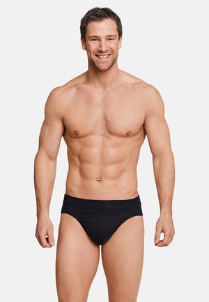 Slip neri a coste con vita alta, design aderente e senza loghi o motivi visibili. Tessuto dalla texture liscia.