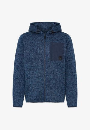 Sudadera con cremallera de punto azul, con capucha ajustable y un bolsillo de parche en contraste en color azul marino. Puños acanalados. Tejido texturizado en toda la prenda.