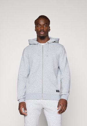 Grey zip-up hoodie with a kangaroo pocket, drawstrings, and ribbed cuffs. Soft fabric with a subtle texture, suitable for casual wear.