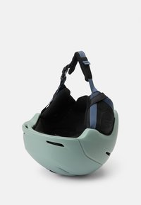 Jasnozielony kask o gładkiej powłoce, regulowane czarne i niebieskie paski oraz wyściełane wnętrze dla komfortu i bezpieczeństwa.