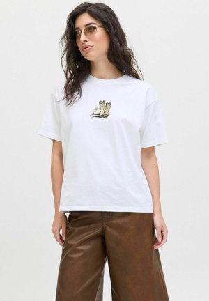 T-shirt en coton blanc avec un motif de bottes et des éléments ludiques. Manches courtes, coupe décontractée, design minimaliste et texture douce.