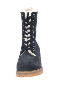 Botín de ante azul marino con un cuello forrado de lana, que presenta ojales de metal y cordones oscuros, y una suela de goma gruesa.