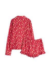 Rode katoenen pyjama set met een lange mouwen top en schattige shorts, versierd met gouden feestelijke patronen, waaronder peperkoekmannetjes en kerstbomen.
