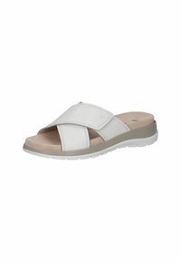 Sandale en cuir blanc à glissière avec deux lanières croisées, semelle intérieure rembourrée et épaisse semelle en caoutchouc. Texture subtile et design minimaliste.
