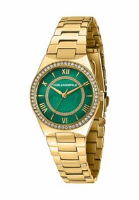 Orologio in metallo tono oro con quadrante verde, numeri romani e dettagli di cristalli intorno alla lunetta; presenta un design con bracciale a maglie.