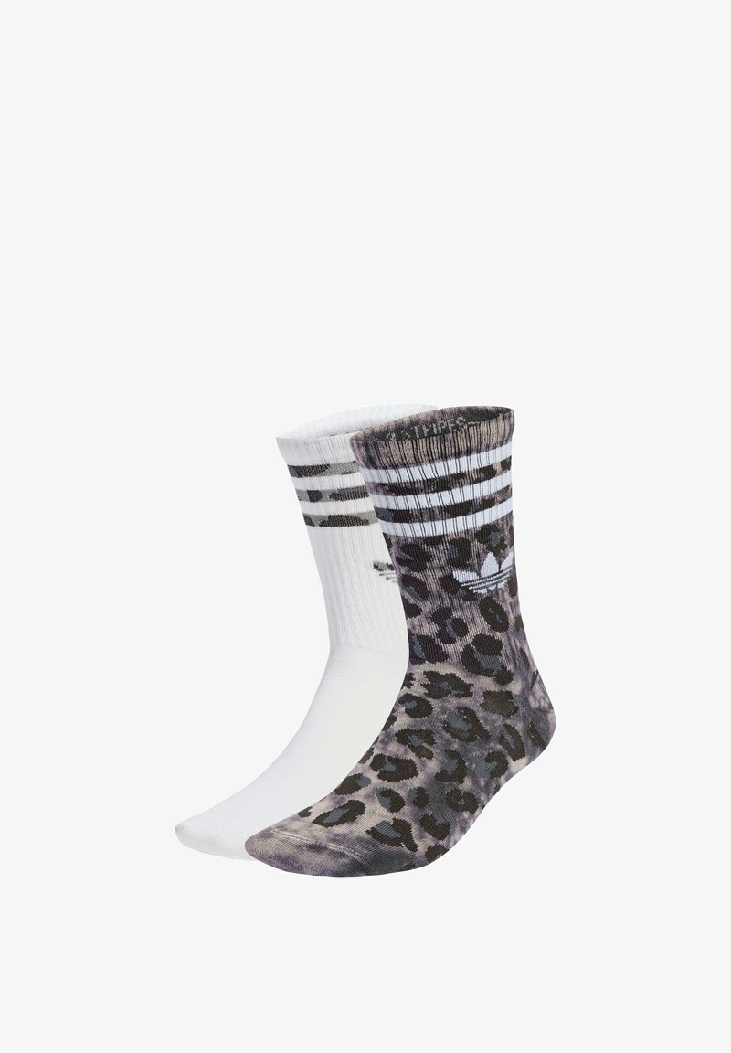 Pair of socks: one solid white, the other features a gray leopard print. Both have a striped ribbed cuff with an Adidas logo.