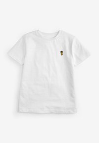 T-shirt in cotone bianco con un piccolo design ricamato giallo e nero a forma di impronta di zampa sul lato sinistro del petto. Maniche corte, colletto girocollo.