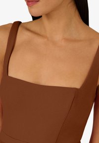 Braunfarbenes Kleid mit quadratischem Ausschnitt und breiten Trägern, glatter Textur, figurbetontem Design und dezenten Nahtdetails, die eine schlanke Silhouette betonen.