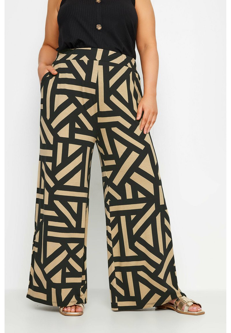 Pantalones de pierna ancha en negro y beige que presentan patrones geométricos intersecados, tela suave, una cinta elástica en la cintura y bolsillos laterales.