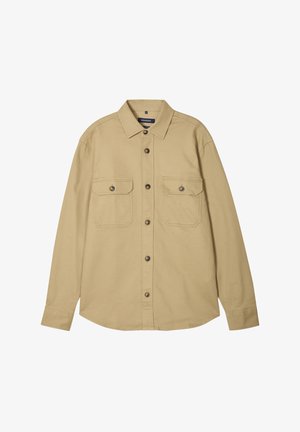 Beige overhemd met knopen, gemaakt van katoen, met een standaard kraag, twee borstzakken en een licht gebogen zoom. Bevat bruine knopen.