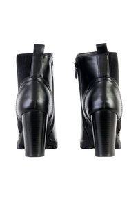 Botines de cuero negro con tacón alto, cremallera lateral y paneles elásticos texturizados. Acabado suave con un diseño de tacón cuadrado estándar.