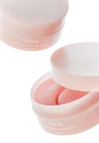 Boîte pour patchs oculaires rétiniens PDRN, en plastique dégradé rose avec un couvercle lisse. À l'intérieur, deux patchs oculaires en gelée texturés sont visibles.