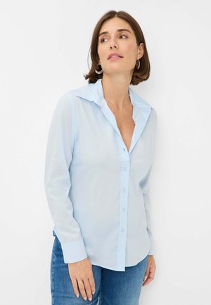 Lichtblauw button-up shirt met lange mouwen, een kraag en een voorste knoopsluiting. Gemaakt van een gladde stof, met een relaxte pasvorm en manchetten.