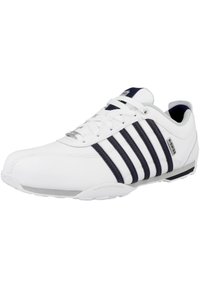 Weißer Sportschuh mit einem glatten Leder-Obermaterial und synthetischen Streifen in Navy. Verfügt über runde Schnürsenkel, gepolsterten Schaft und Gummisohle für Rutschfestigkeit.