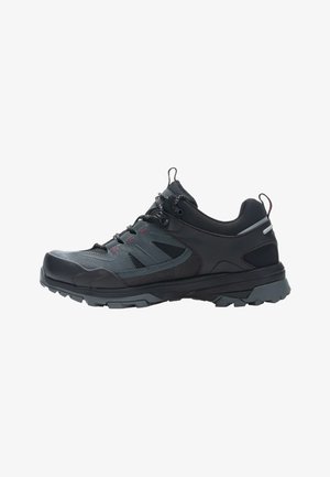 Zapatilla de senderismo negra y gris oscura con cierre de cordones, suela resistente y collar acolchado, mostrada en perfil lateral sobre fondo blanco.