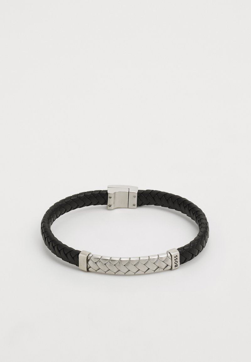 Black braided leather bracelet featuring a silver-tone clasp and a textured metal center detail with an engraved brand name.