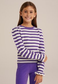 Violet ir balti dryžuoti megztiniai ilgomis rankovėmis ir raukšlėtais rankogaliais; minkšta mezgimo tekstūra; derinami su violetinėmis raukšlėtomis kelnėmis.