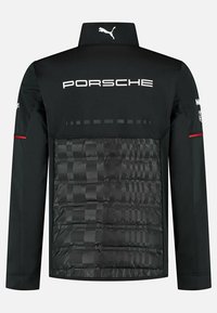 Czarna kurtka z wysokim kołnierzem, z pikowaną strukturą na plecach, logo Porsche oraz brandingiem Puma. Czerwony akcent na rękawach.