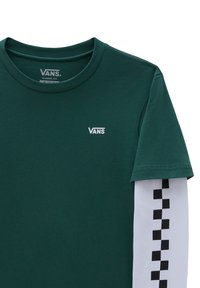 Groene katoenen t-shirt met korte mouwen en wit Vans-logo op de borst, en zwart schaakbordpatroon op de mouw. Klassieke pasvorm.