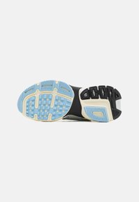 Shoe sole features patterned rubber with blue and black accents, ridged texture, and a white midsole. Includes cushioning elements for traction.