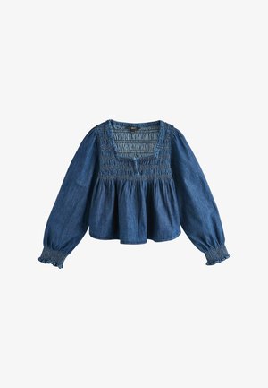 Blouse en denim à manches longues avec empiècement froncé, encolure carrée, taille péplum froncée et poignets smockés bordés de volants.