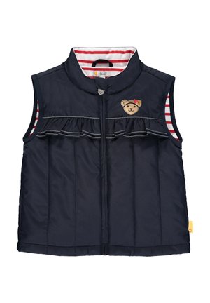 Gilet matelassé bleu marine sans manches avec fermeture éclair devant, détail froncé sur la poitrine, doublure intérieure rayée rouge et blanche, et visage d'ours brodé avec une fleur.