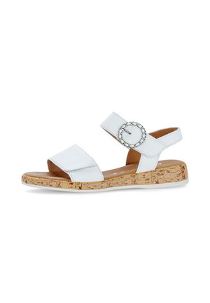 White sandal featuring a cork sole and a broad strap with a circular silver buckle accent. Smooth texture and open-back design.