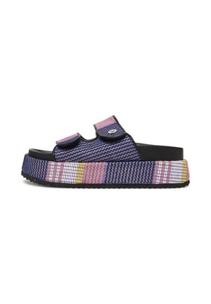 Platform sandal with purple, pink, yellow, and white woven fabric, adjustable straps, and black sole against white background.