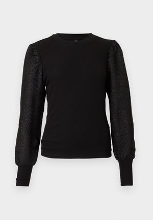 Top negro ajustado de manga larga con mangas abullonadas y transparentes con textura y puños acanalados, sobre un fondo blanco liso.