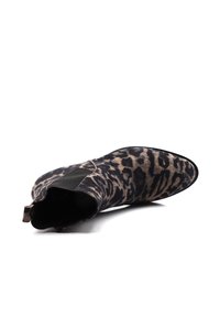 Kotníkové boty s leopardím vzorem z nubuku, s špičatou špičkou a elastickými bočními panely. Barevná paleta černé, béžové a hnědé.