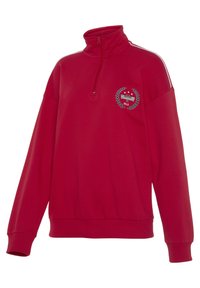 Red sweatshirt with a high collar, half-zip closure, long sleeves, and white side stripes. Features an embroidered logo on the chest.
