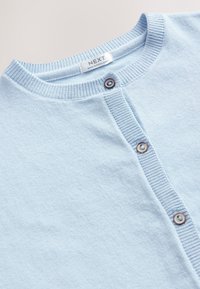 Light blue button-up cardigan with a ribbed neckline and button closure. Soft texture with contrasting dark buttons. Label visible.
