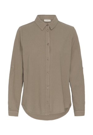 Chemise à manches longues, boutonnée, de couleur marron clair, avec un col pointu et des boutons sur le devant ainsi que sur les manches.