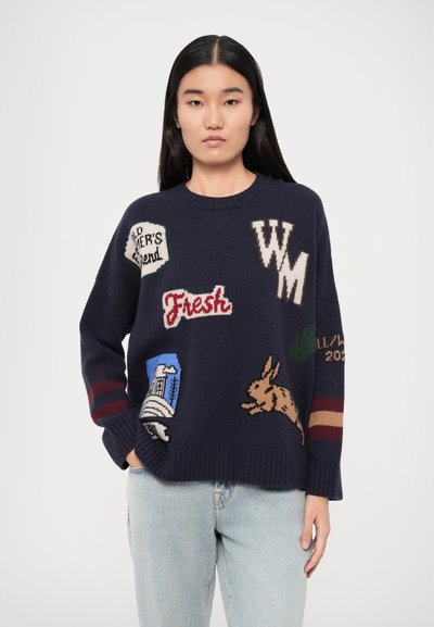 Dark blue knitted sweater featuring various colorful knitted patches, including text and animal motifs. Ribbed cuffs and hem. Casual fit.