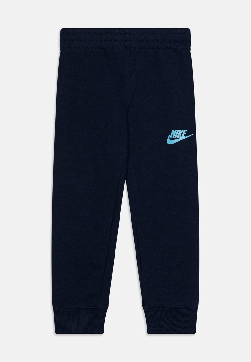 Pantalones de chándal Nike en azul marino, hechos de algodón, con un diseño ajustado, cinturilla elástica y un logo en azul claro en el muslo izquierdo.