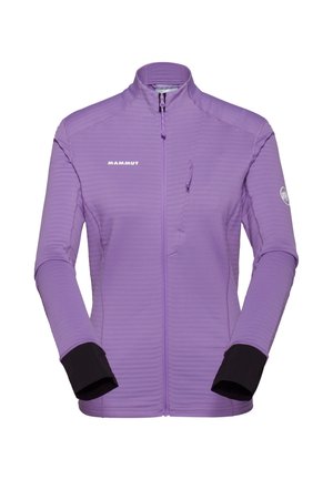 Lilla Mammut jakke med lynlås, høj krave, lange ærmer, sorte indermanchetter og en brystlomme med lynlås på højre side.