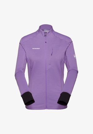 Lilla Mammut jakke med lynlås, høj krave, lange ærmer, sorte indermanchetter og en brystlomme med lynlås på højre side.