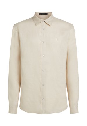 A bézs színű, hosszú ujjú vászon ing gombos gallérral, hat elülső gombbal és diszkrét logóhímzéssel a mellrészen.