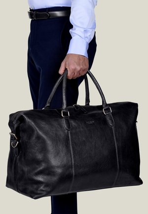 Black leather duffel bag with two sturdy top handles, zip closure, and silver-tone hardware. Smooth texture with visible stitching details.