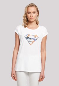 White cotton t-shirt featuring a colorful floral diamond logo on the front. Short sleeves and a rounded neckline.